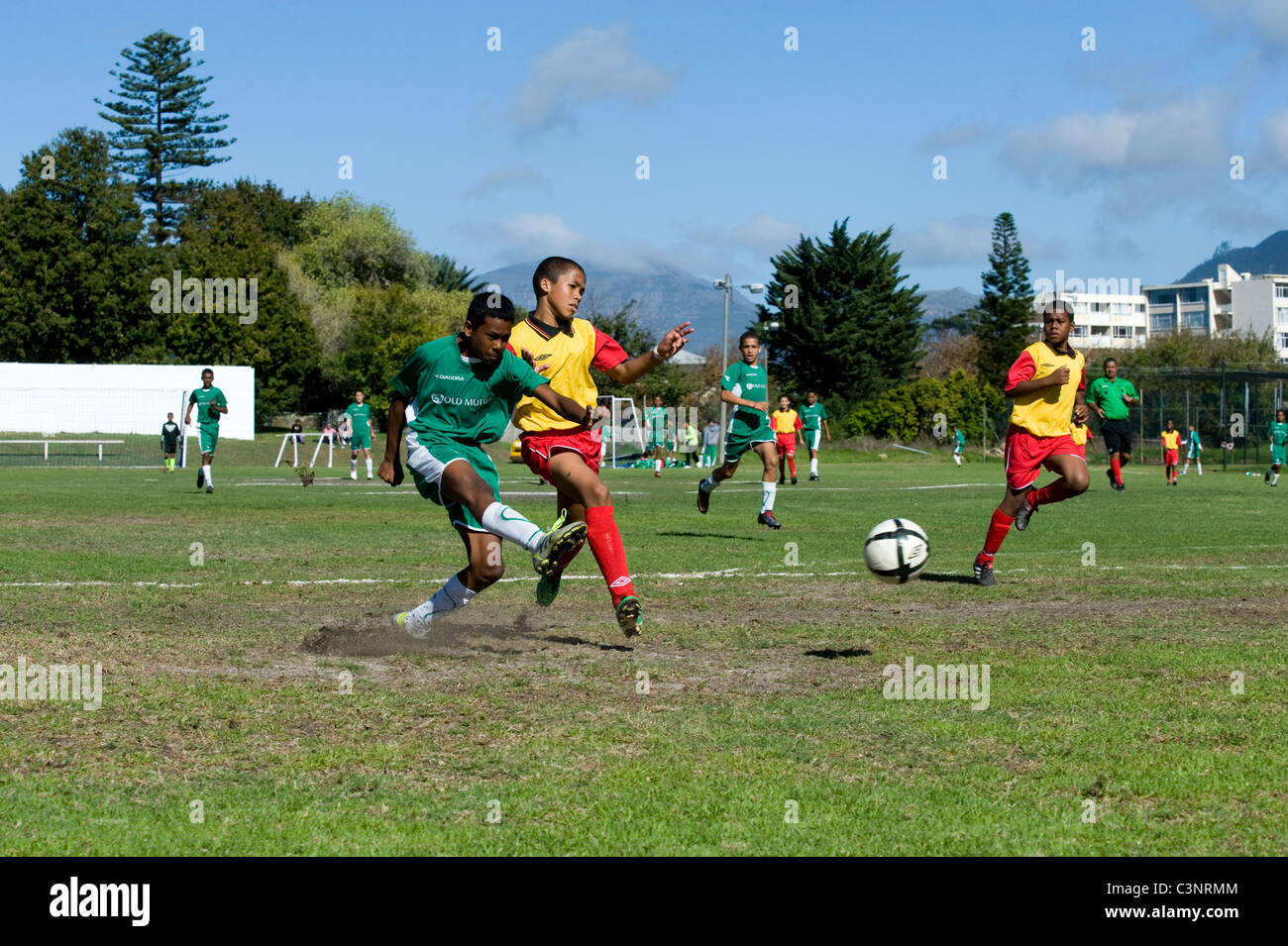 El cerradero y defensor de un equipo de fútbol U13 en un partido en Cape Town, Sudáfrica Foto de stock