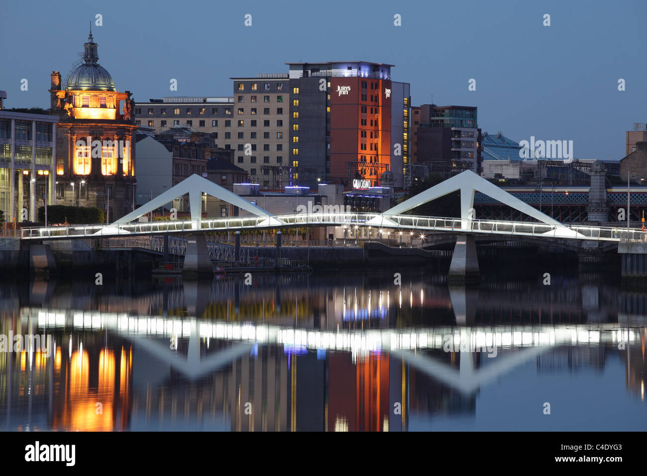 Trdesson puente peatonal y de bicicletas sobre el río Clyde por la noche, Glasgow, Escocia, Reino Unido Foto de stock