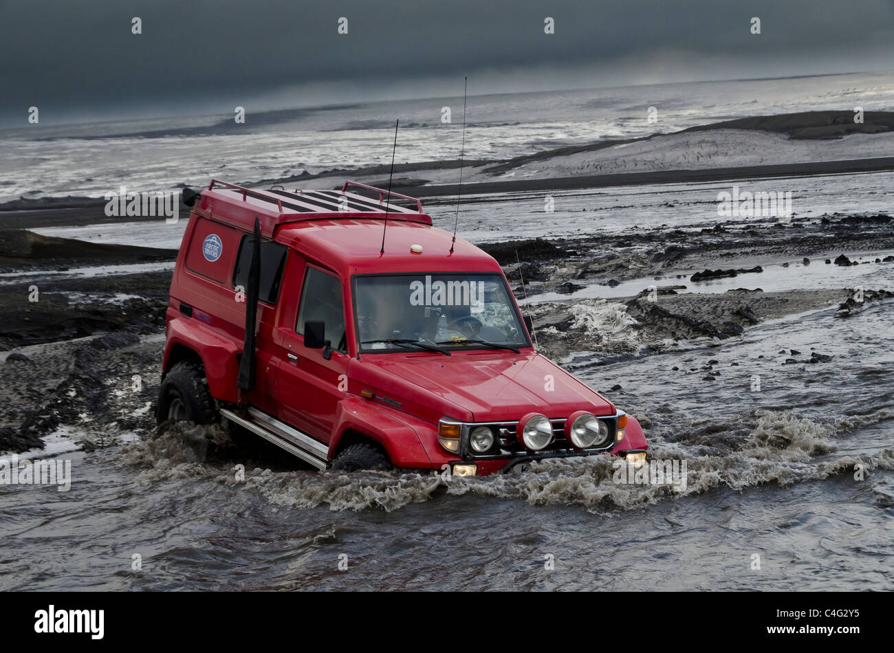 Rojo grande cruzando el río glacial Tungnaa lleno de cenizas de la erupción volcánica Grimsvotn, Islandia Foto de stock