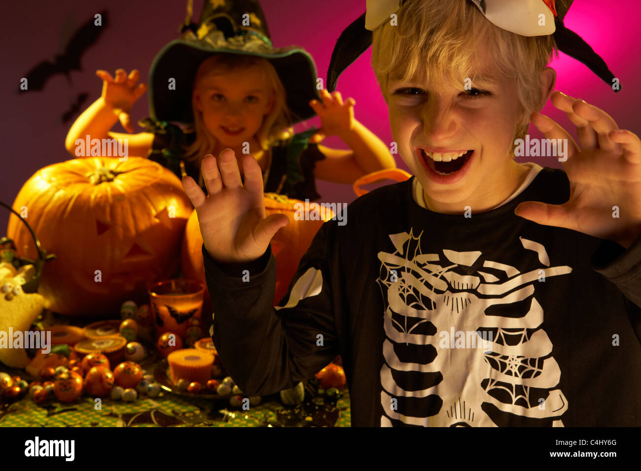 Fiesta de Halloween con niños que vestían trajes asustando Foto de stock