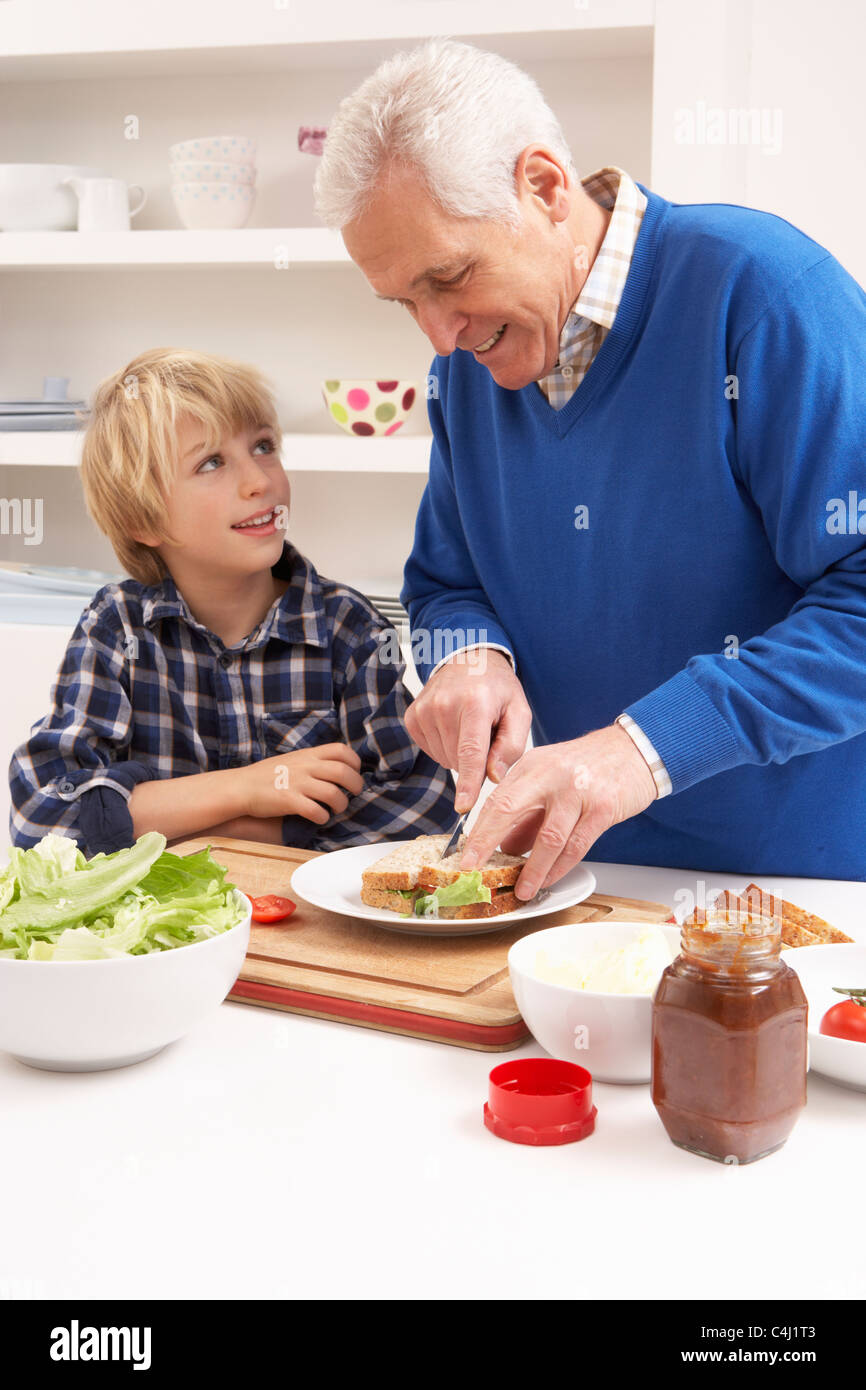 Abuelo y nieto haciendo Sandwich en Cocina Foto de stock