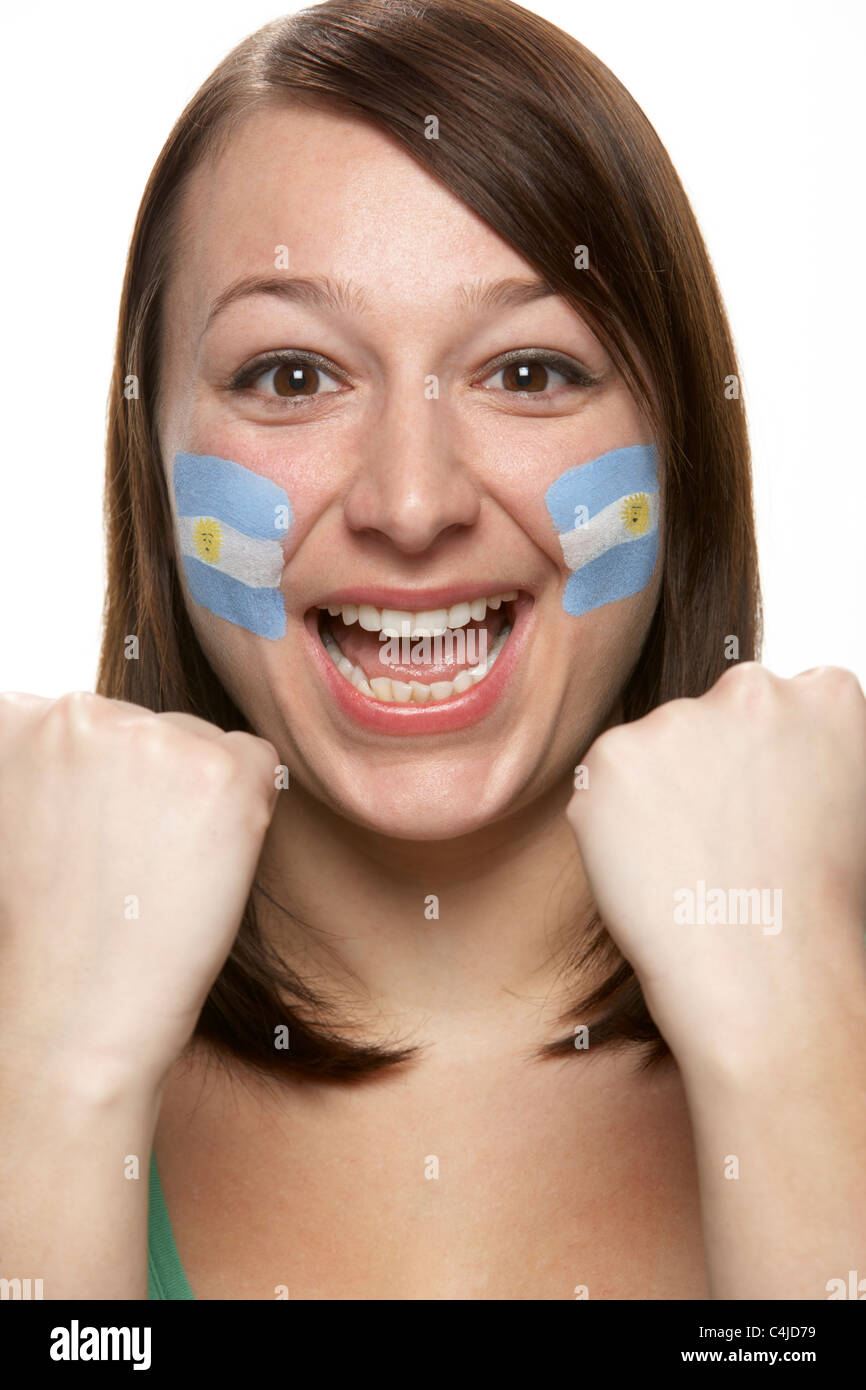 Mujer joven hincha con Bandera Argentina pintada en la cara Foto de stock