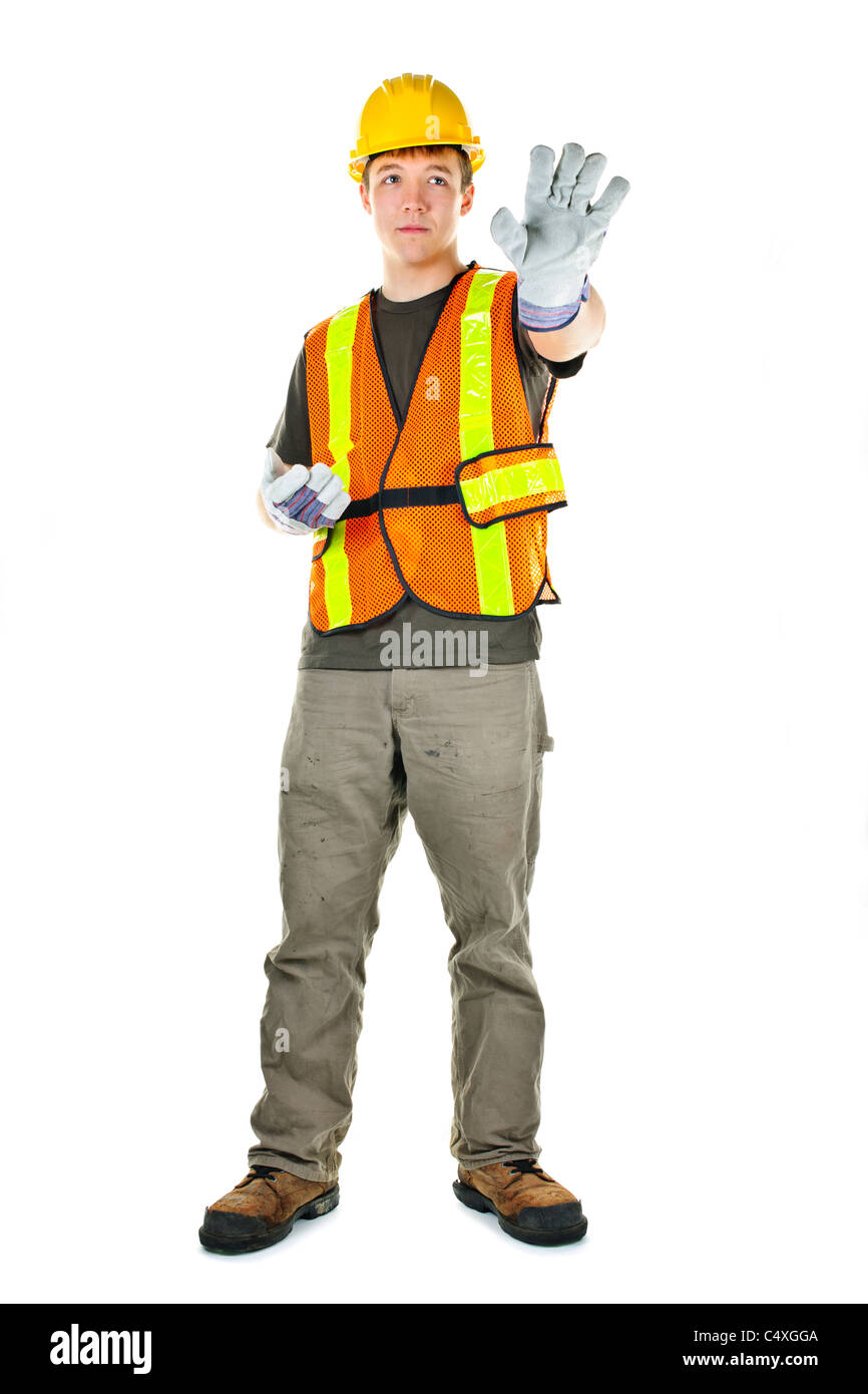 Macho, trabajador de la construcción dirigiendo con señales de mano en el chaleco y el sombrero duro Foto de stock