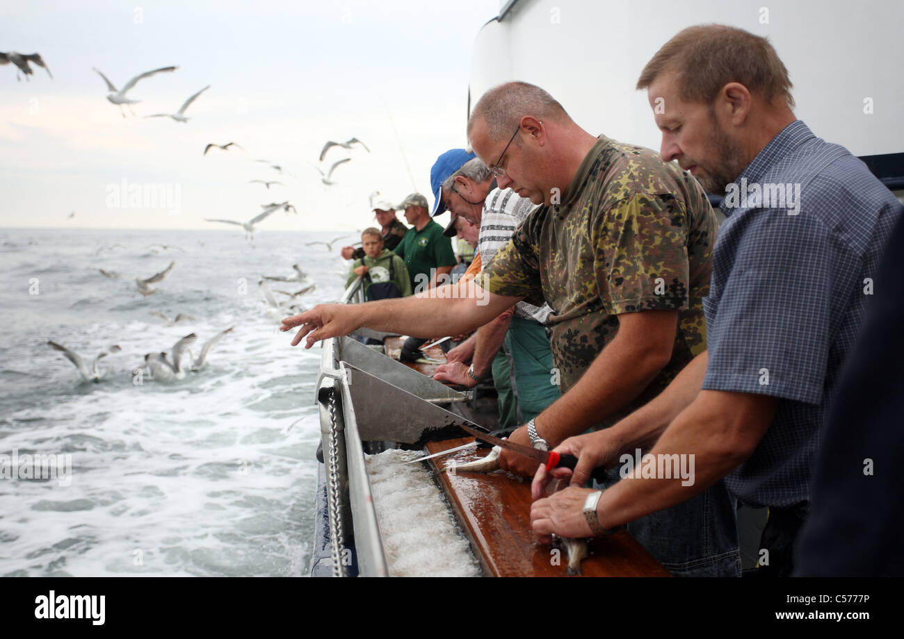 Los hombres durante la pesca de mar profundo Foto de stock