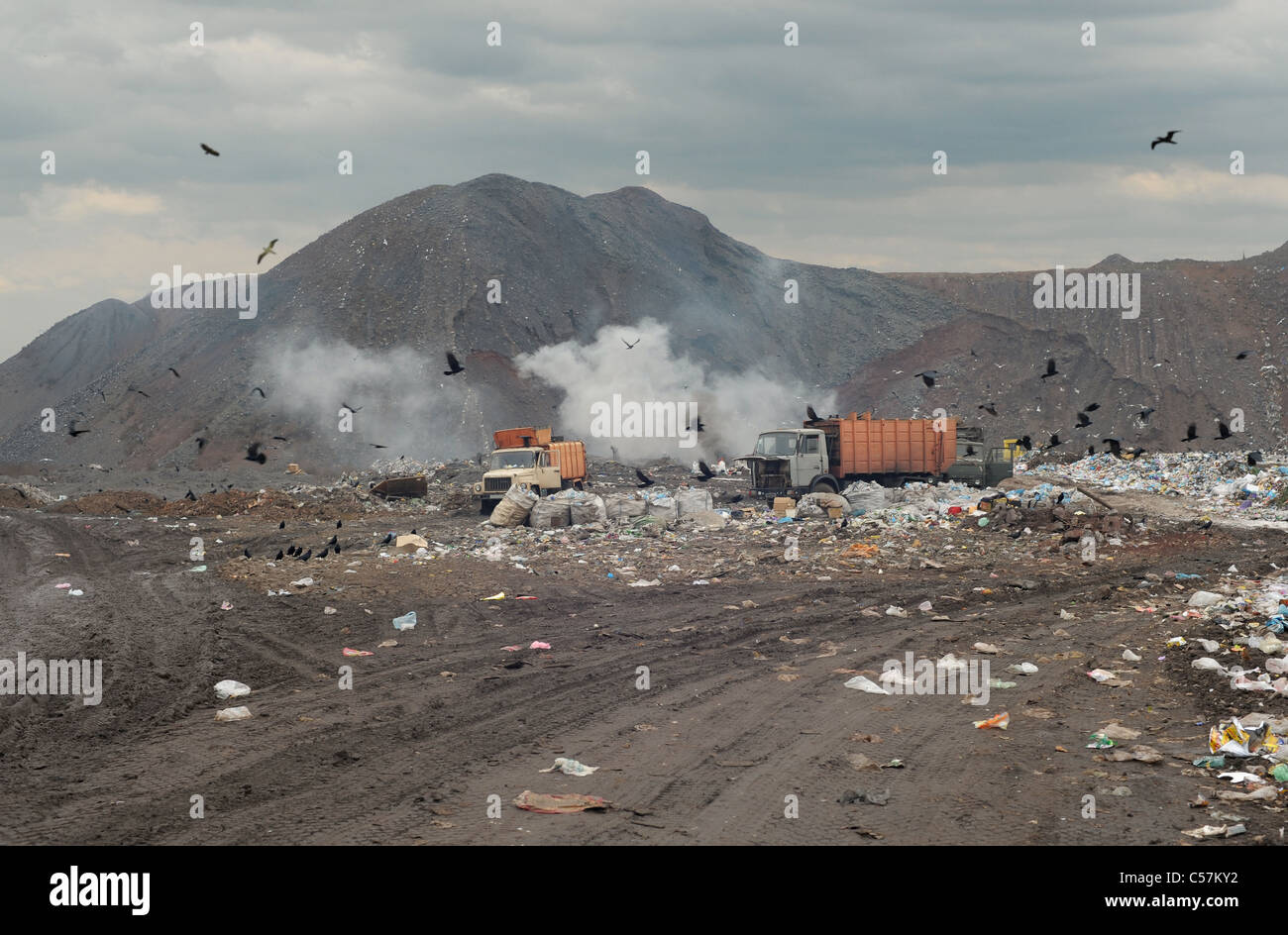 Los camiones de la basura en un basurero de la ciudad de polvo Foto de stock