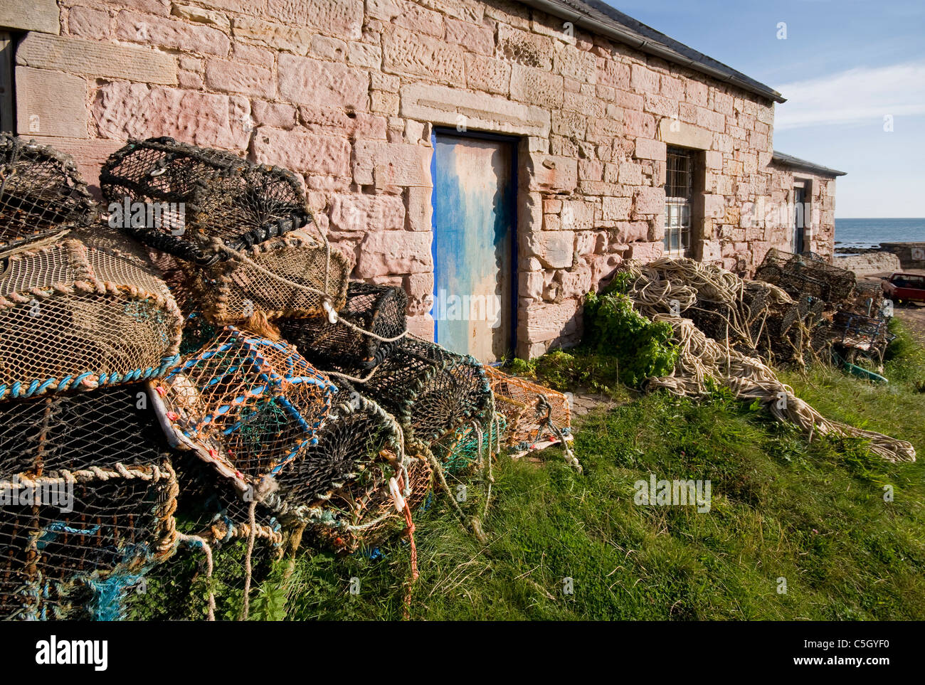 Los restos de pesca y creels abandonados por Fisherman's Cottage Cove por St Abbs Foto de stock