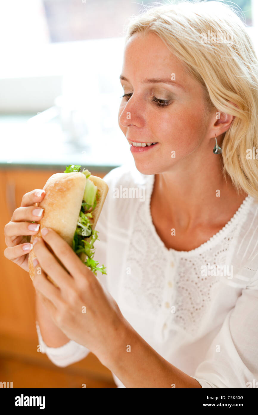 Chica rubia comiendo sándwiches saludables Foto de stock