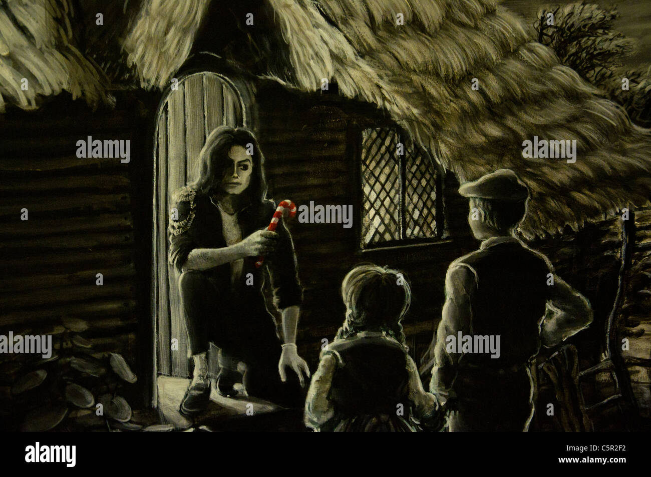 Banksy imagen de Michael Jackson ofreciendo caramelos a los niños en una cabaña en el bosque, Bristol, Inglaterra Foto de stock