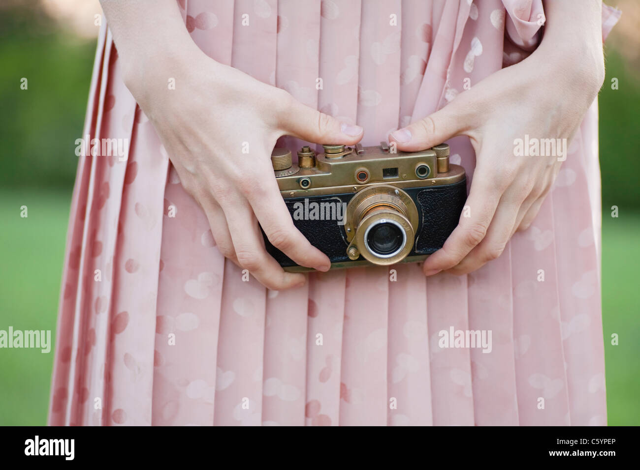 Rusia, Voronezh, parte media de mujer sosteniendo vieja cámara Foto de stock