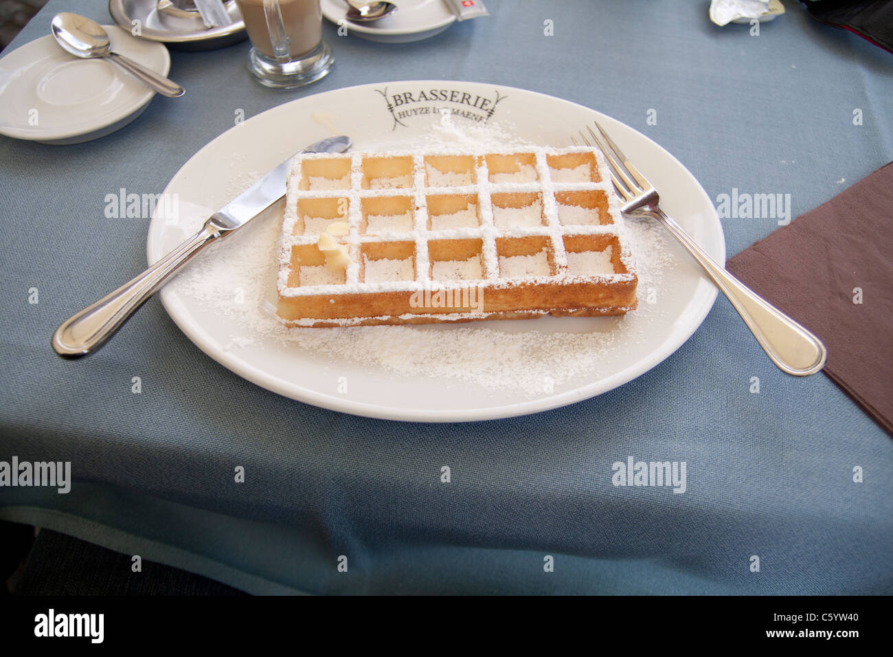 Gofre belga espolvoreado con azúcar glas en un plato en Brujas, Bélgica Foto de stock