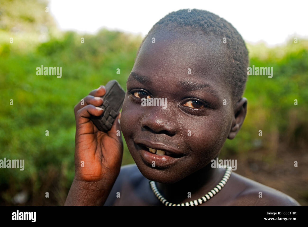 Niño etíope posando con su barro hizo celular toy Etiopía. Foto de stock