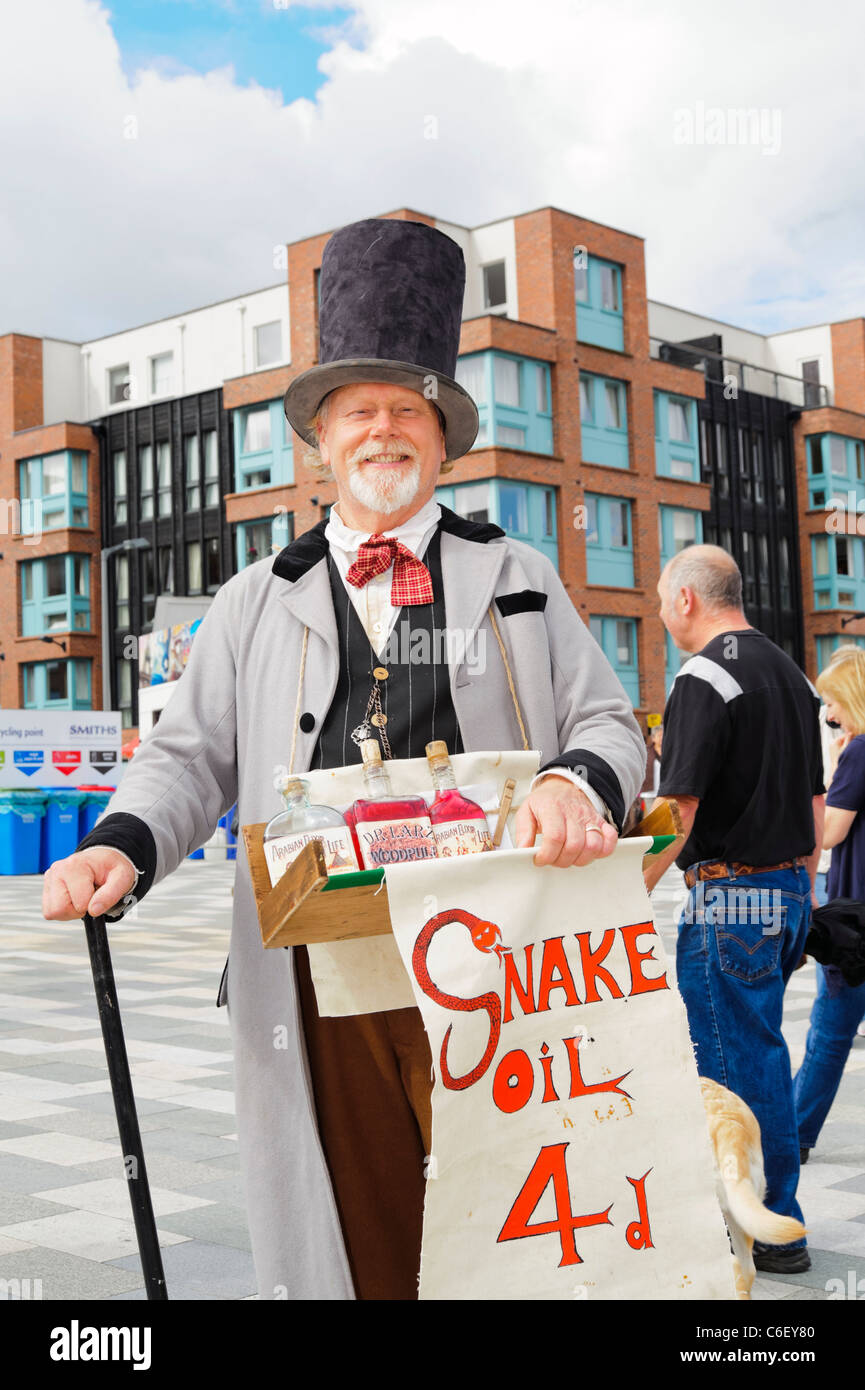 Vendedor de aceite de serpiente atraca en Gloucester, Inglaterra, Reino Unido. Hombre en trajes de época vendiendo aceite de serpiente. Foto de stock