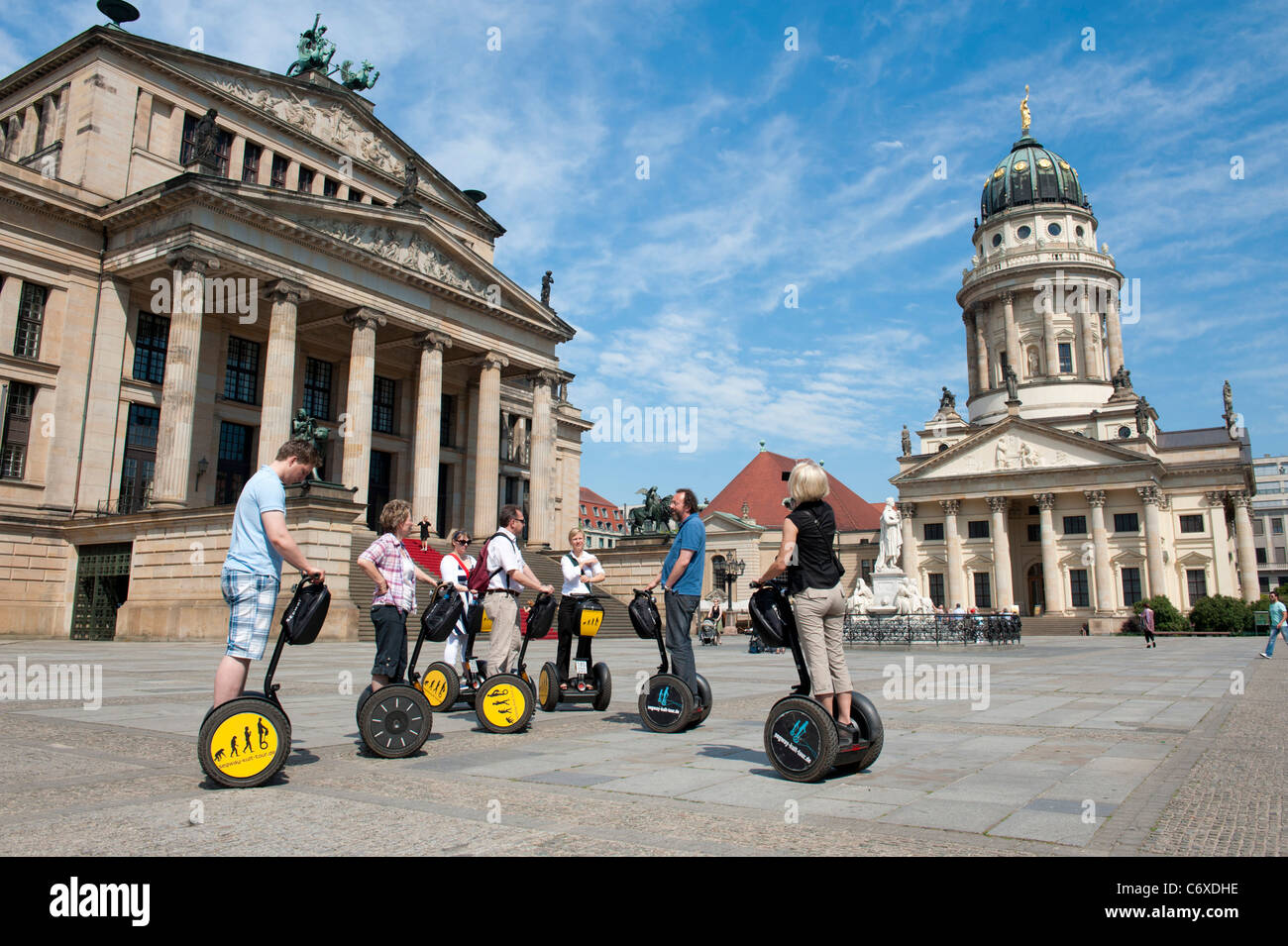 Los turistas de segway en la plaza Gendarmenmarkt y Konzerthaus y Franzosischer Dom en el distrito Mitte de Berlín, Alemania Foto de stock