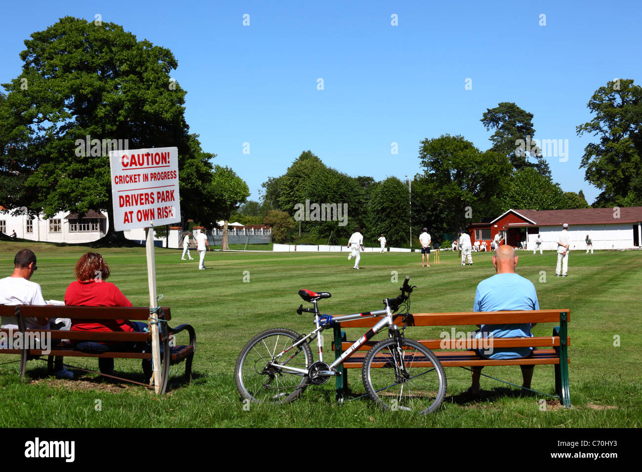 Señal de advertencia a los conductores que aparcan junto al campo de cricket a su propio riesgo mientras un partido está en curso, Southborough Common, Kent, Inglaterra Foto de stock