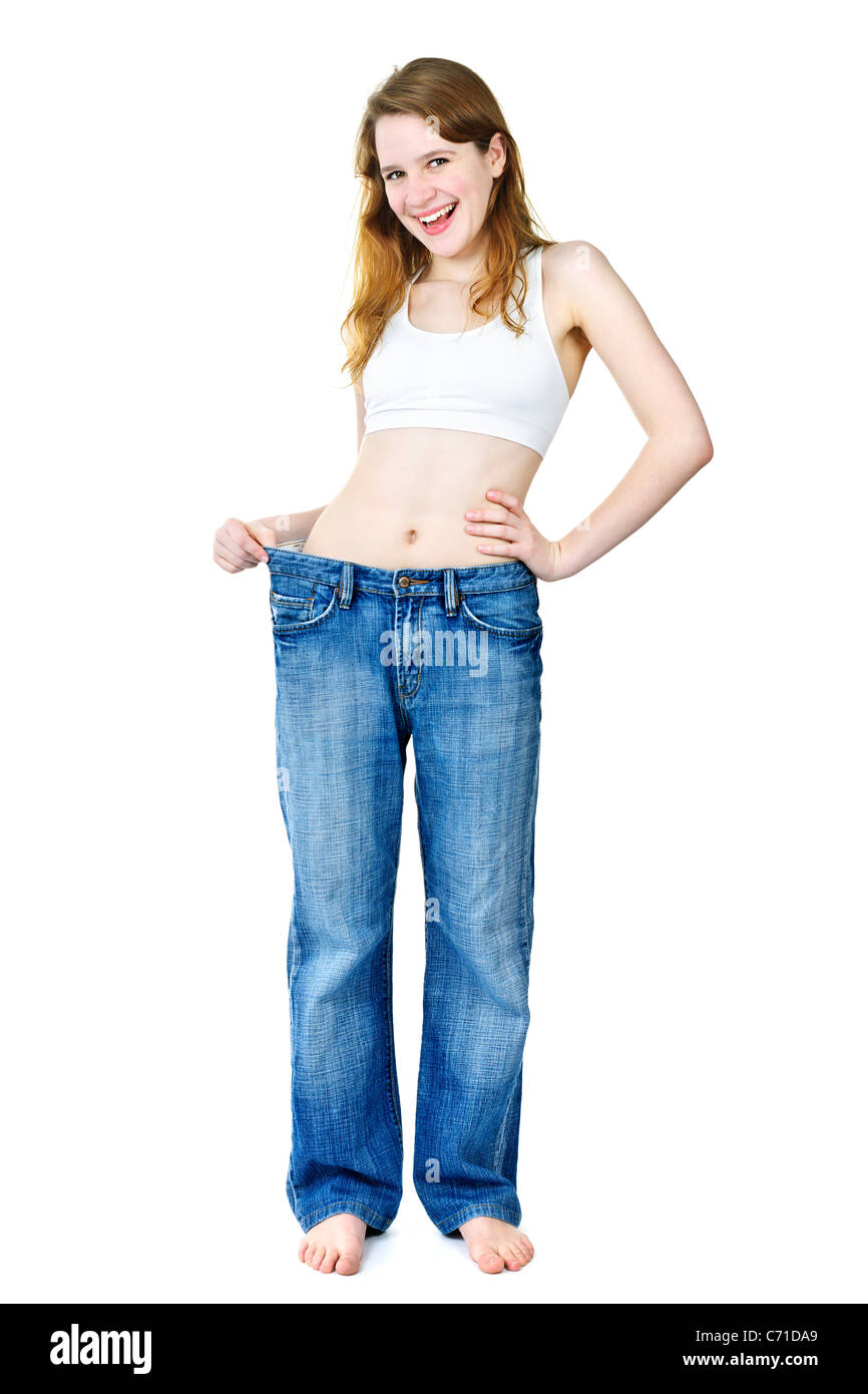 Colocar feliz joven en viejos jeans suelto después de perder peso aislado  en blanco Fotografía de stock - Alamy