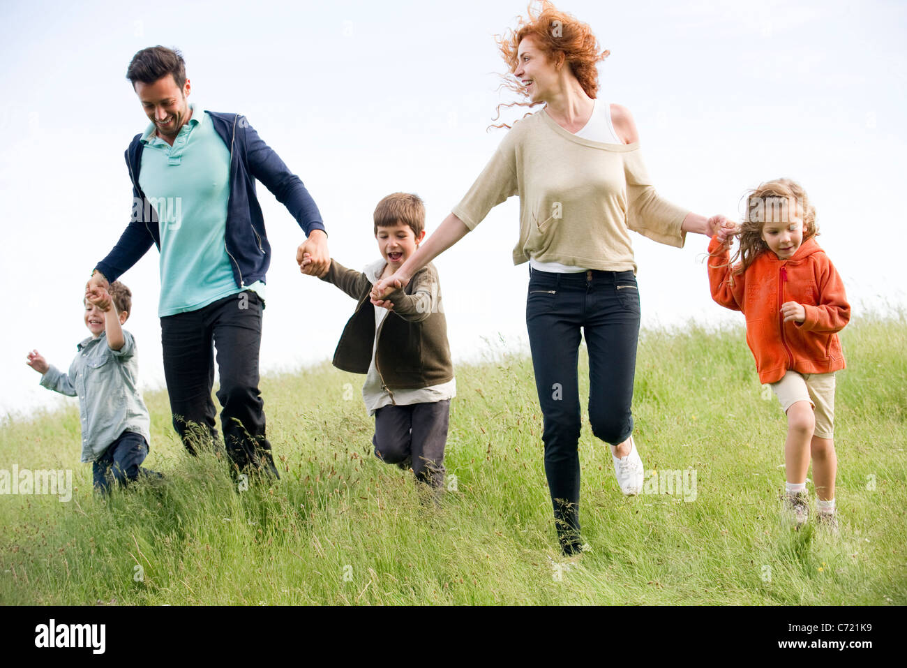 Familia correr juntos en el campo Foto de stock