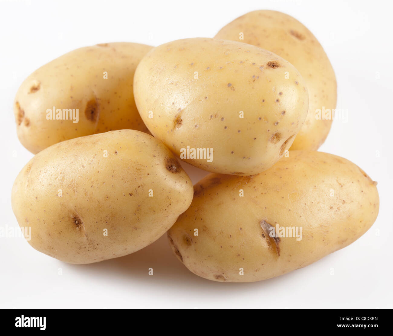 Las patatas sobre un fondo blanco. Foto de stock