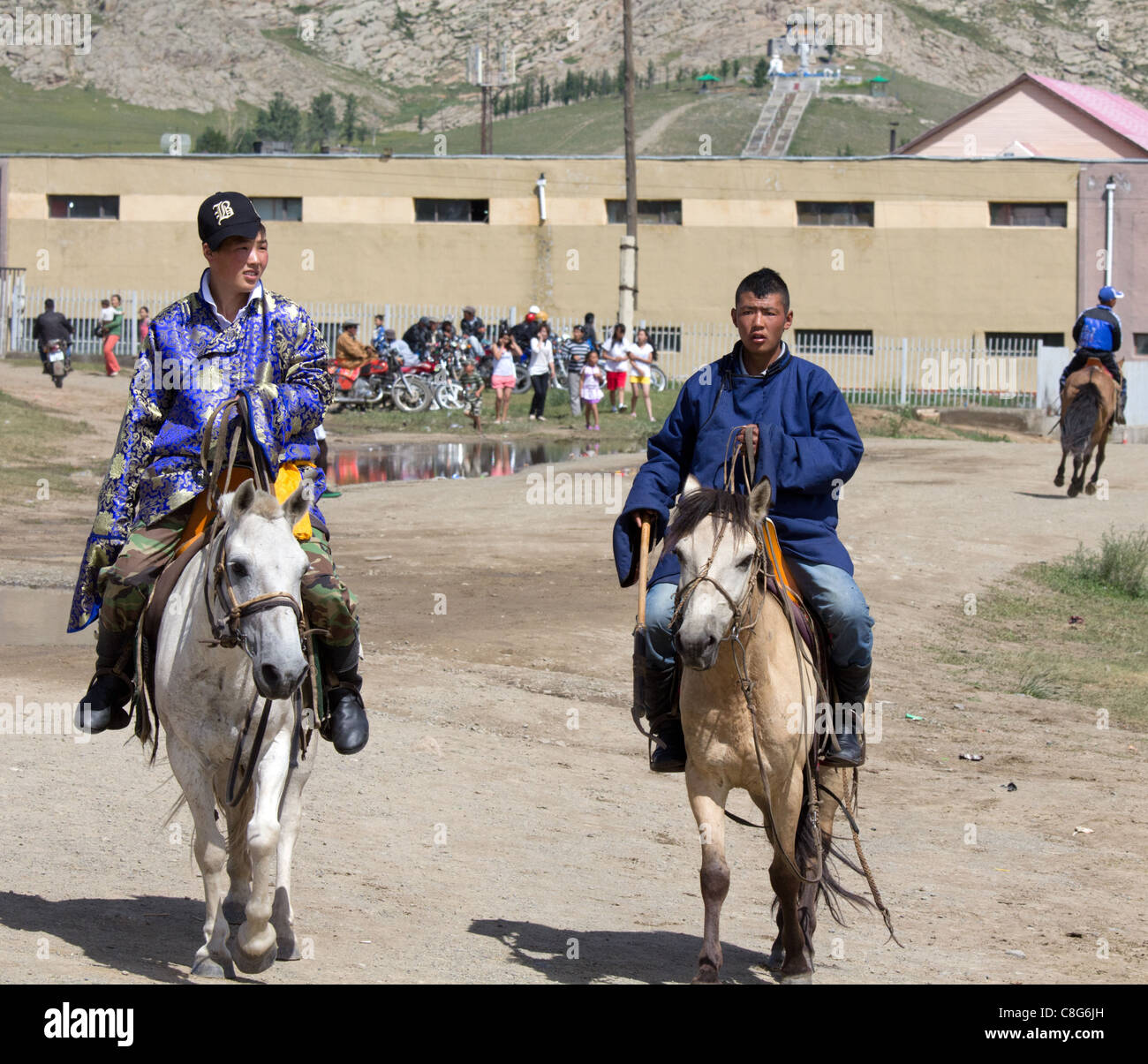 En el Naadam Tsetserleg dos mongoles ride al estadio vistiendo el traje tradicional. Foto de stock