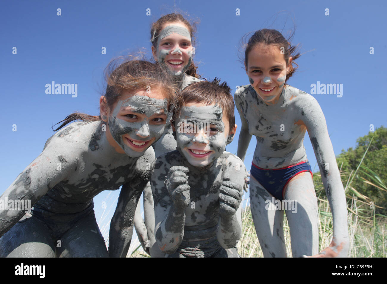 Los niños cubierto con un fango curativo jugar en la playa, Tuzlata resort cerca de la ciudad de Balchik, Costa del Mar Negro, Bulgaria Foto de stock