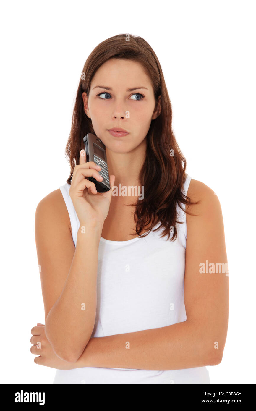 Atractiva mujer joven está a la espera de una llamada de teléfono. Todo sobre fondo blanco. Foto de stock