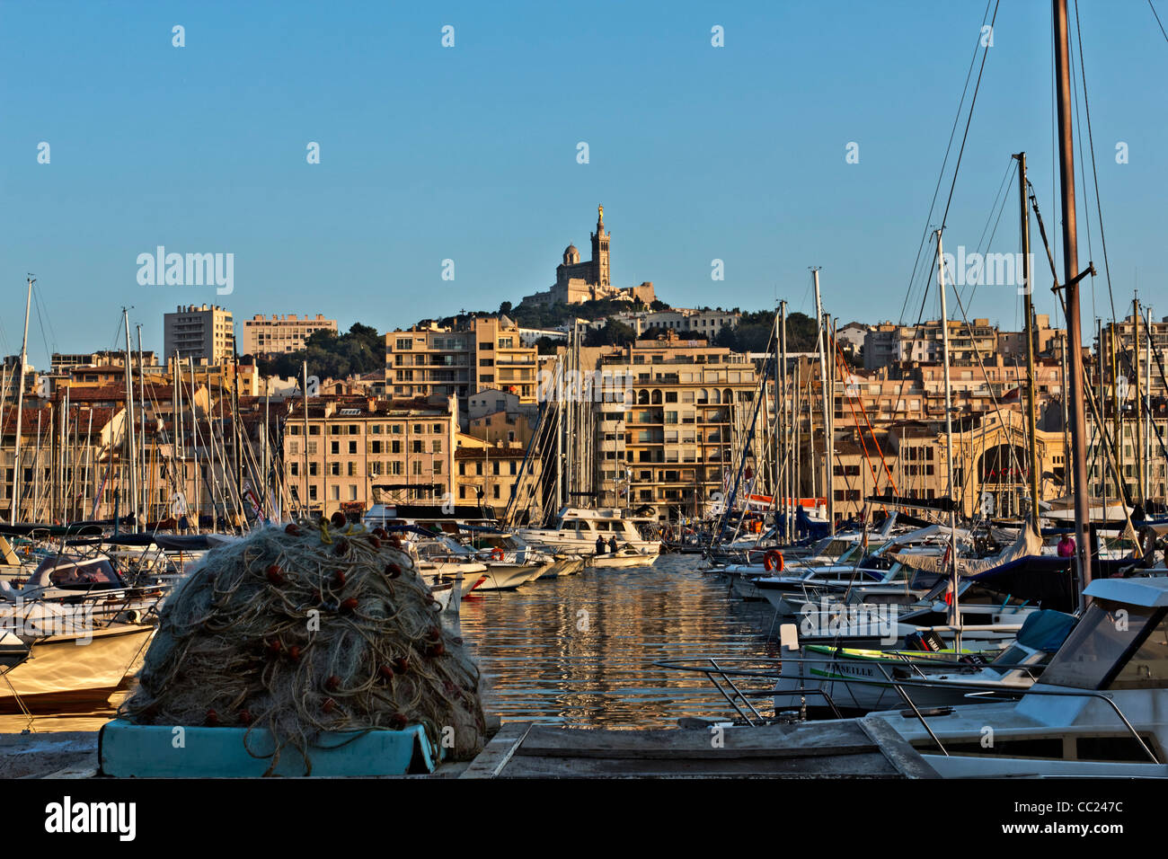 El viejo puerto, Vieux Port, con la Basílica de Notre Dame de la Garde en la distancia, Marsella, Marsella, Provence-Alpes-Côte d'. Foto de stock