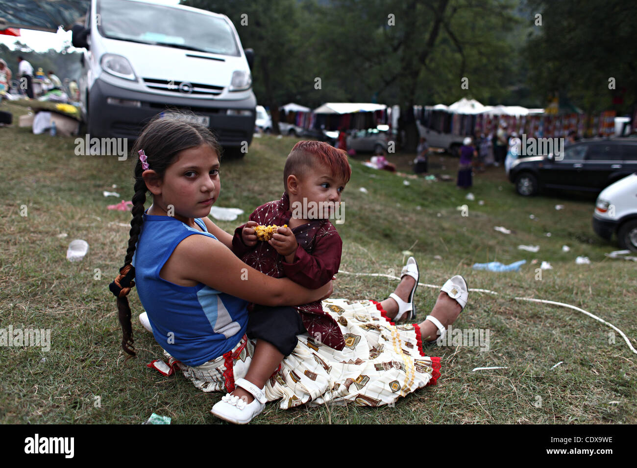 Nina Gitana Sosteniendo Un Bebe Descansa Sobre La Hierba En Costesti Rumania Durante Un Manual Celebation Religioso Que Congrega A Miles De Gitanos Y Rumanos Jueves 8 De Septiembre De 11 Fotografia