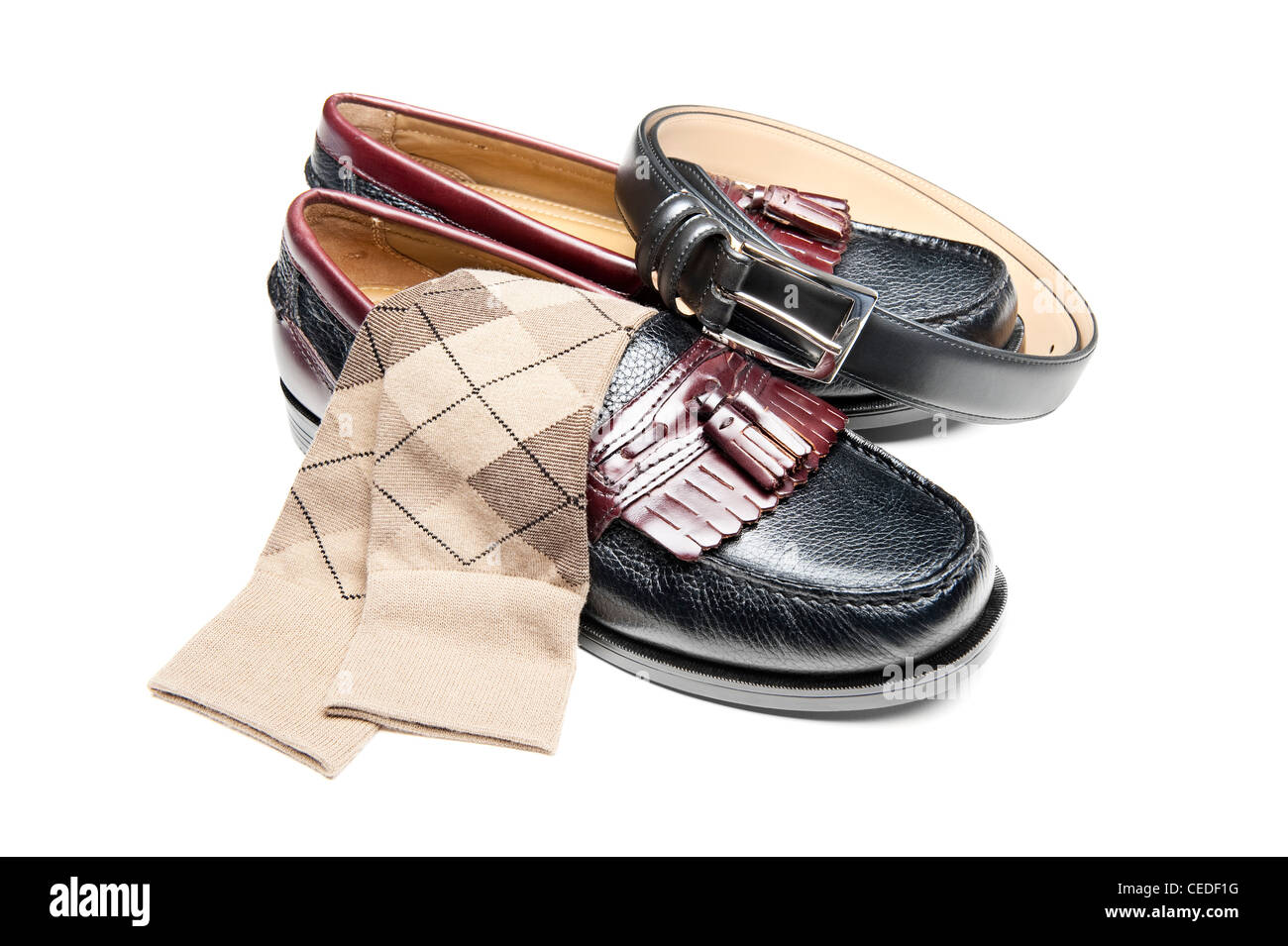 Un nuevo par de deslizamiento en zapatos de vestir con calcetines de bronceado y una correa de cuero negro. Foto de stock