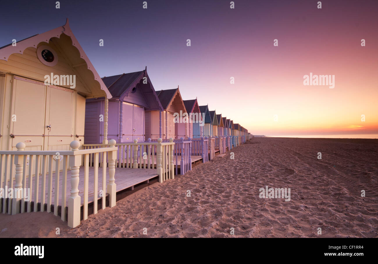 Amanecer sobre nuevas cabañas de playa en la isla de Mersea. Foto de stock