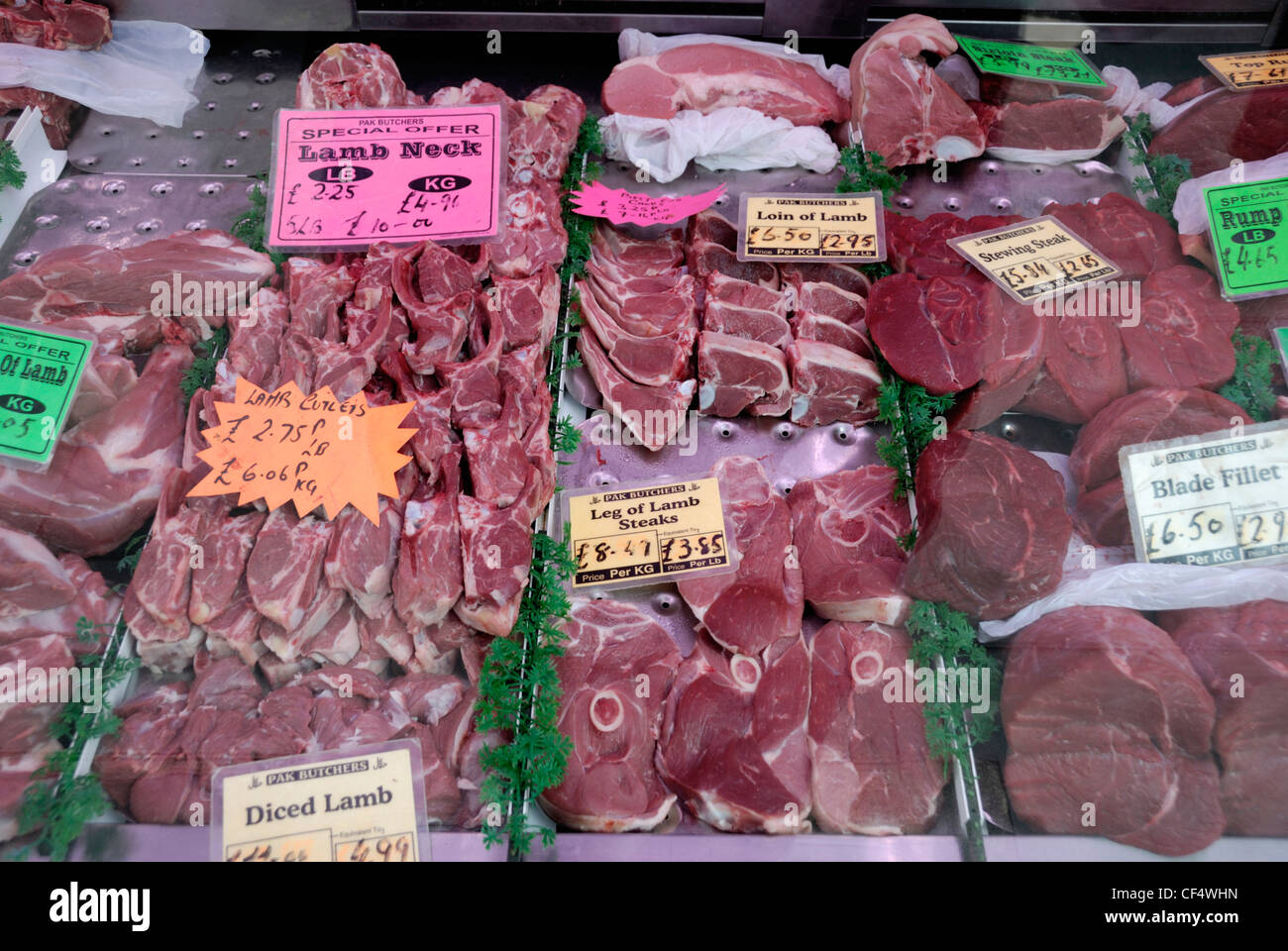 Diferentes cortes de carne roja en la pantalla de la ventana de una carnicería. Foto de stock