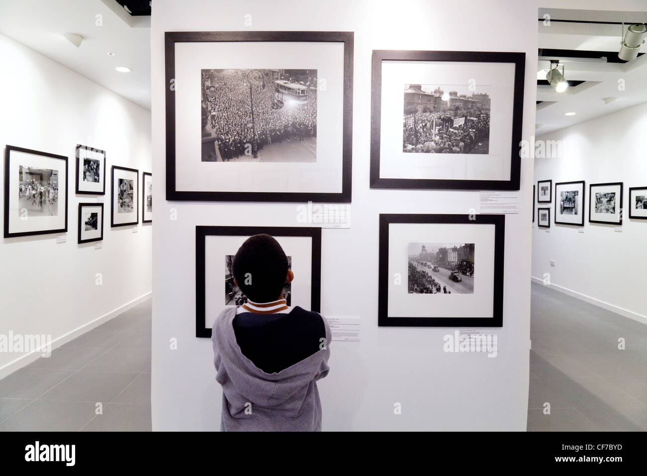 Un niño mirando fotos en una exposición de arte; el Getty Gallery, el centro comercial Westfield Stratford, Londres, Gran Bretaña. Foto de stock