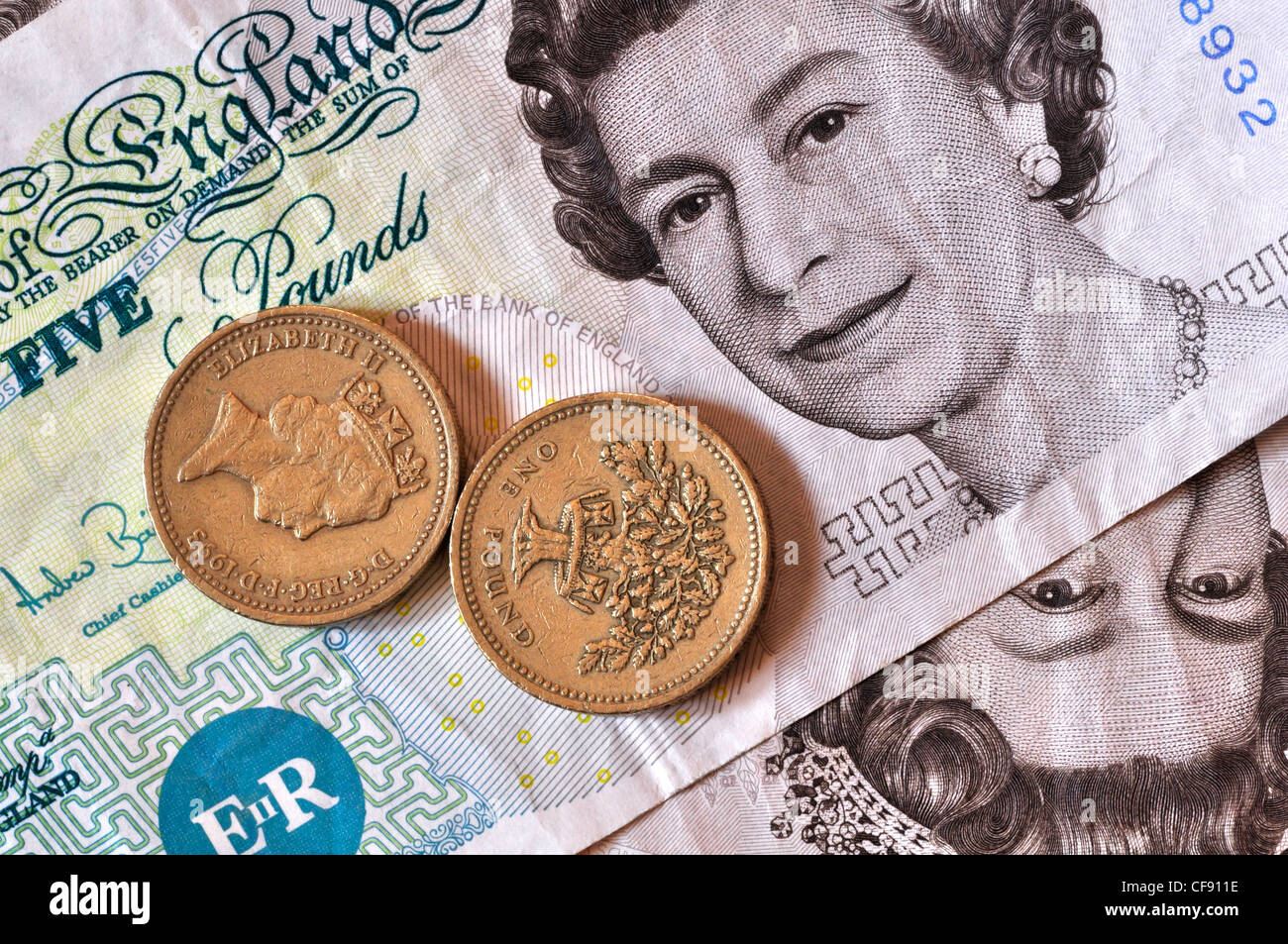 Libra dos monedas establecido en una nota de cinco libras UK Fotografía