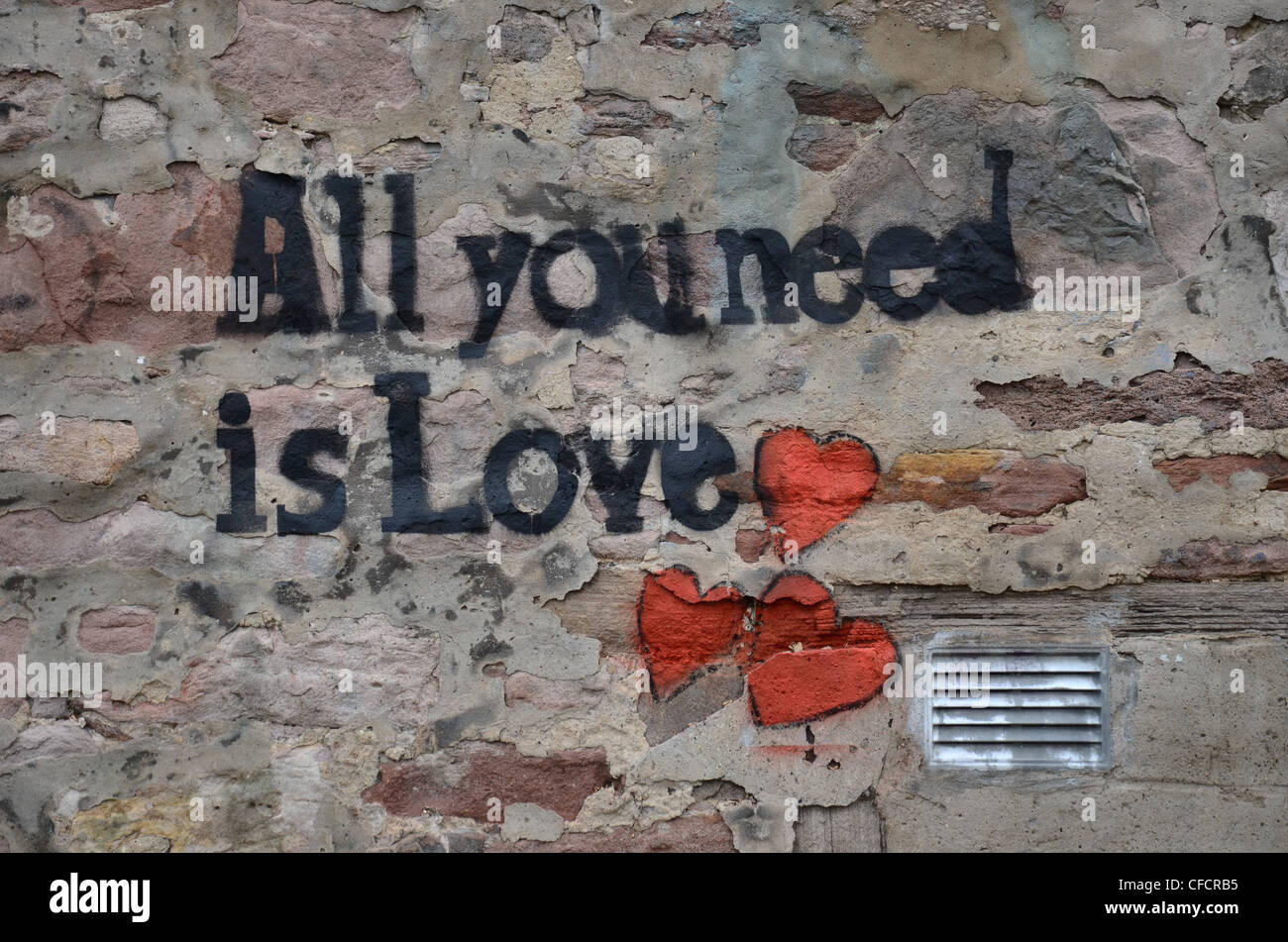 "Todo lo que necesitas es amor' graffiti en una pared de Edimburgo y el título de una canción de los Beatles. Foto de stock