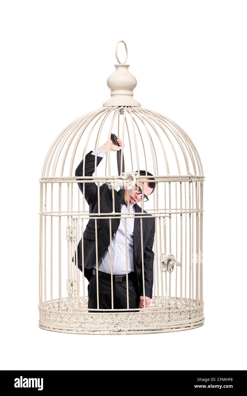 Hombre de negocios suicida encerrado en una jaula. Foto de stock