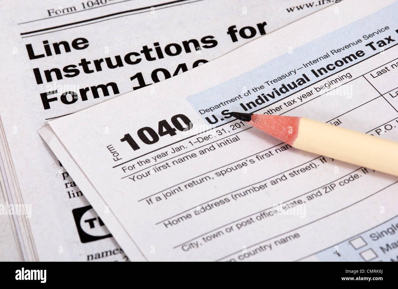 Cierre el formulario de impuestos de los Estados Unidos, el libro de instrucciones y lápiz Foto de stock