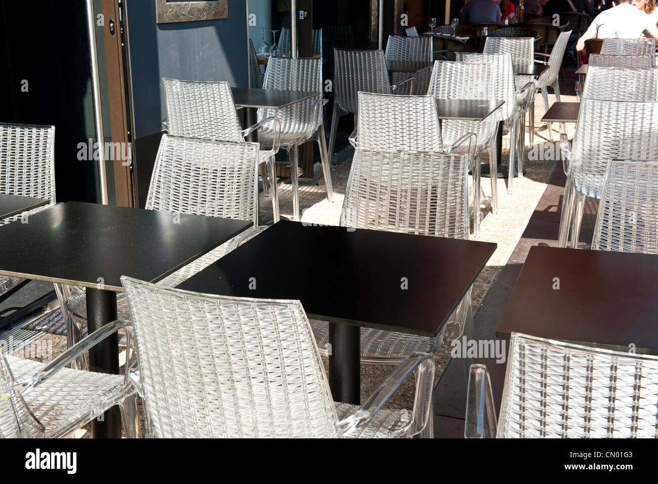 Tejido blanco, sillas de plástico fuera de un restaurante. Foto de stock