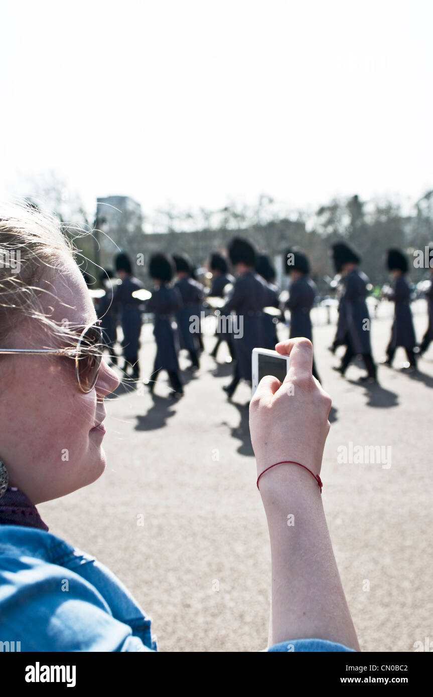 Un turista tomar fotografías en un desfile, guardias de Buckingham Palace Foto de stock