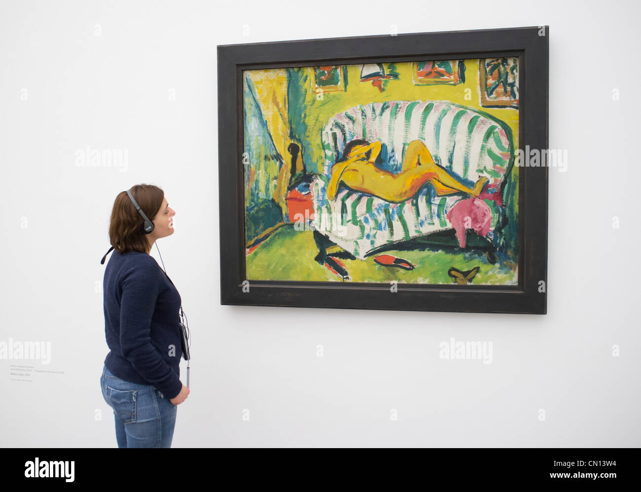 Mujer mirando la pintura Liegendes Madchen por Erich Heckel en la Pinacoteca del museo de arte moderno en Múnich, Alemania Foto de stock