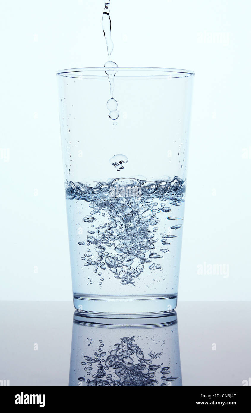 Verter agua en cristal Foto de stock