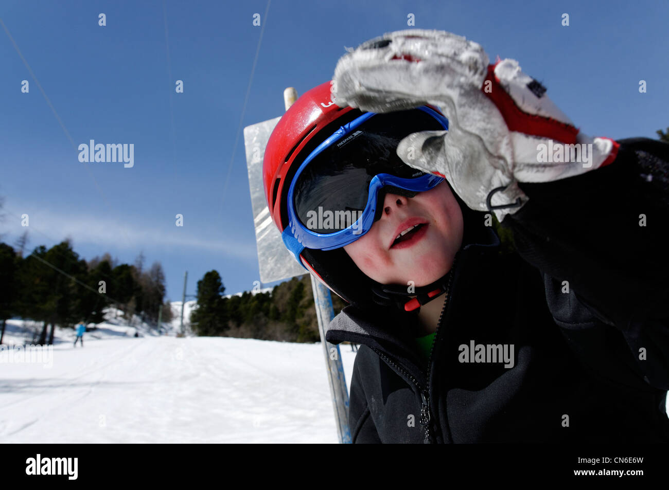 Desde arriba de un niño feliz con ropa abrigada y gafas de esquí