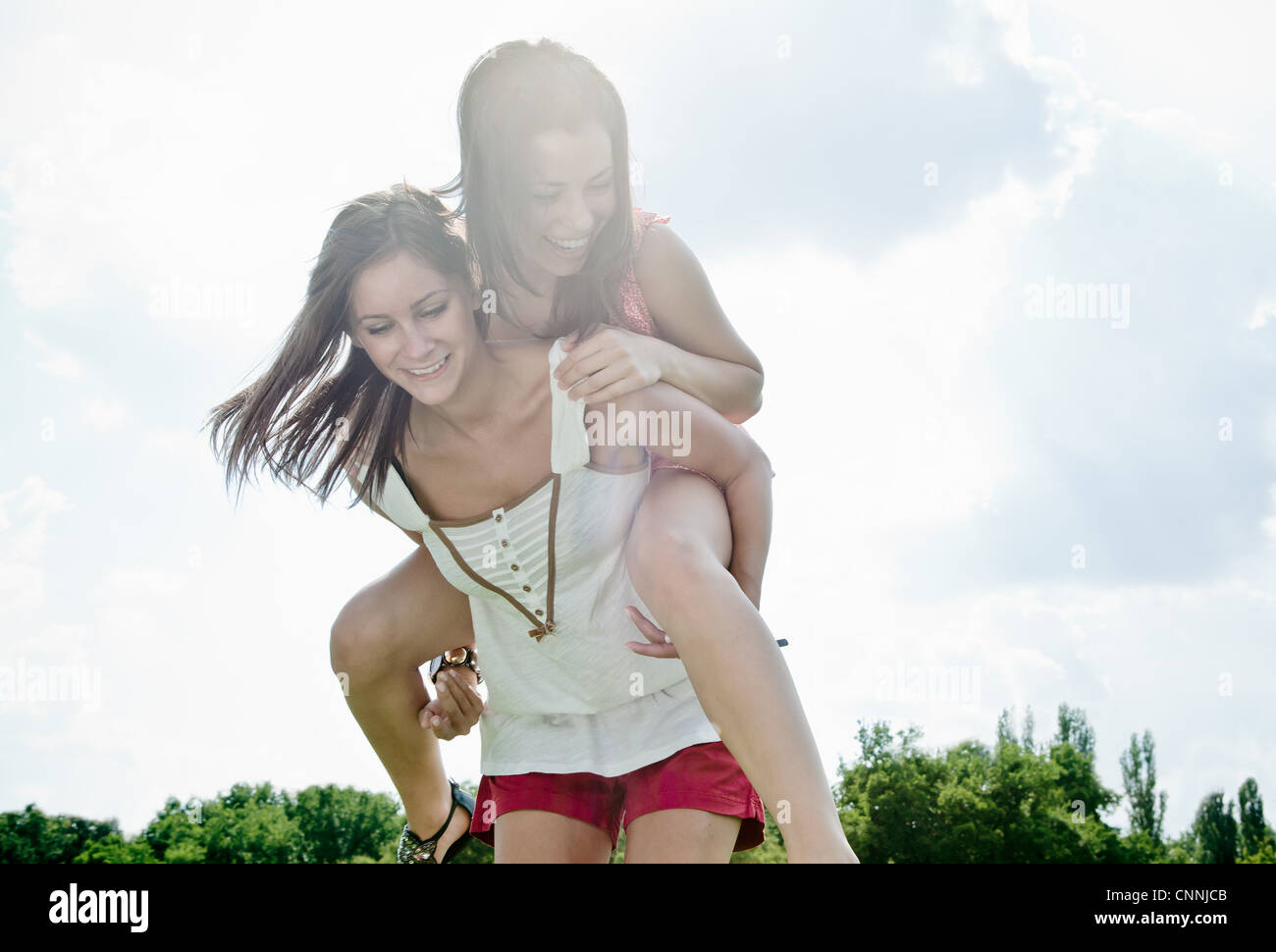 Mujer sonriente jugar afuera juntos Foto de stock