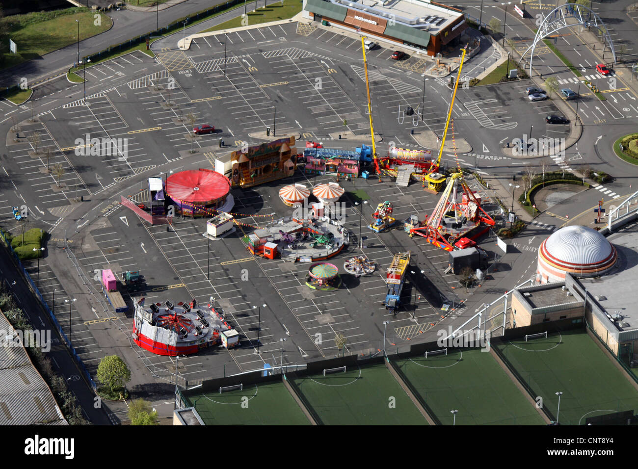 Vista aérea de un parque de atracciones en un aparcamiento a primera hora de la mañana Foto de stock