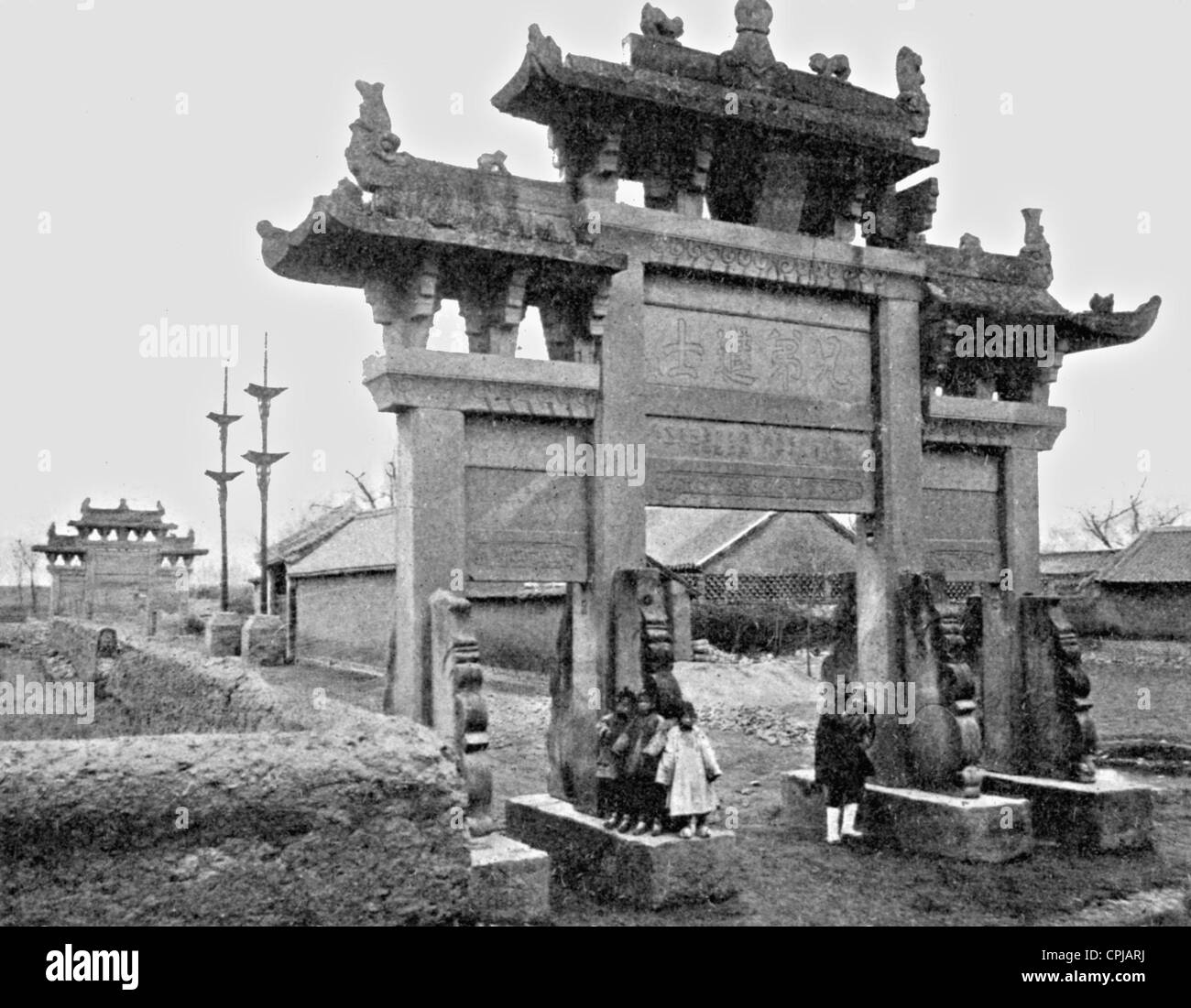 Los niños antes del arco triunfal en Jiaozhou Foto de stock
