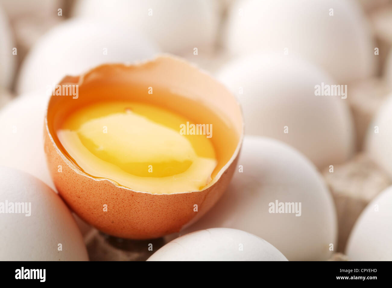 Los huevos de gallina. Un huevo está roto. Foto de stock