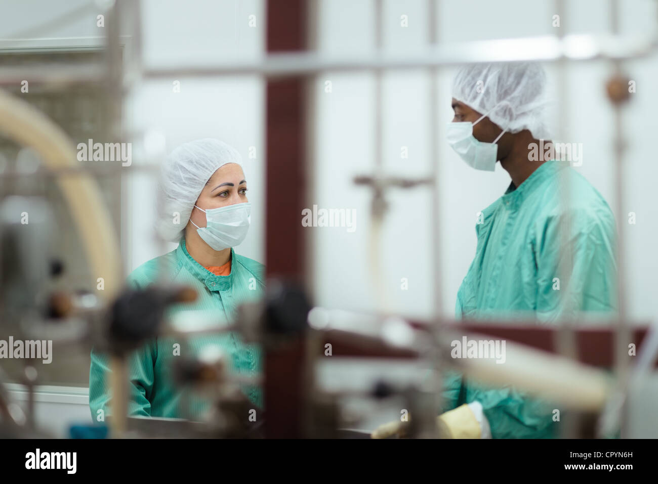 Técnicos de laboratorio médico en el trabajo con maquinaria y equipos de la planta Foto de stock