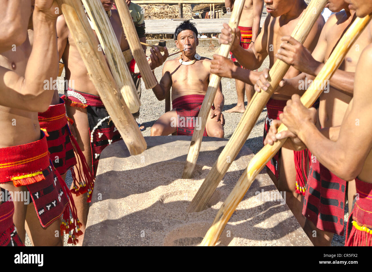 Los miembros de la tribu Samdom muestran su forma tradicional de aplastamiento de los cultivos en el anual Festival de Bucero, , India, Asia Foto de stock