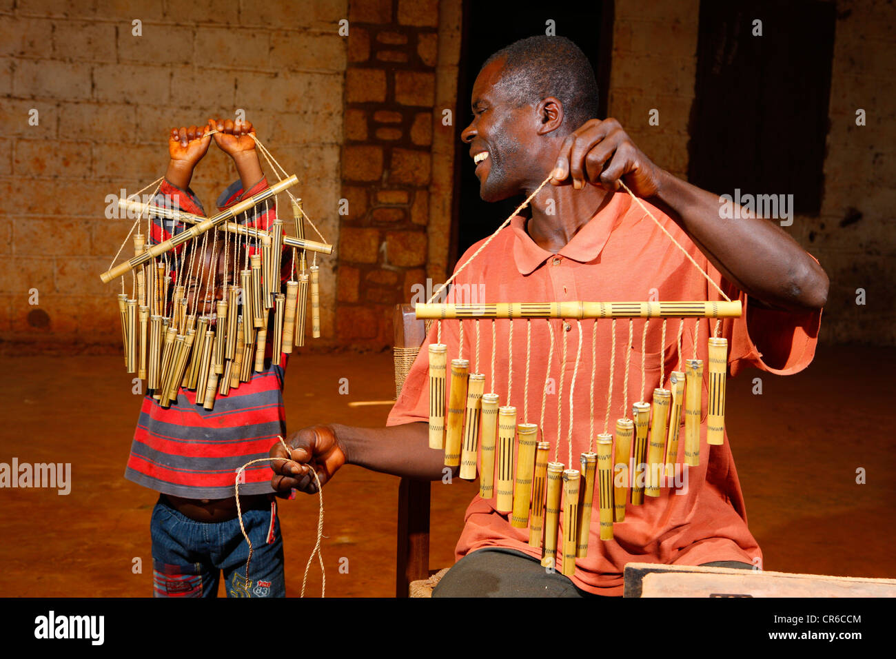 Padre e hijo mostrar fabricado el Wind chimes hechas de bambú, Bafut, Camerún, África Foto de stock