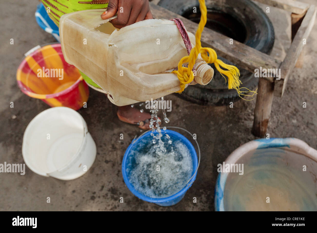 Una adolescente que extrae agua de un pozo en el punto cuatro barrio de Monrovia, Liberia Foto de stock