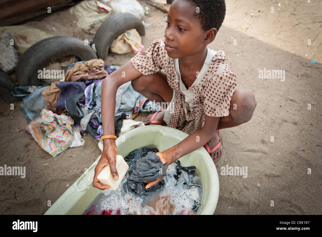 Una chica que lava la ropa a mano en el punto cuatro barrios de Monrovia, la capital del condado de Montserrado, Liberia el jueves 5 de abril de 2012. Foto de stock