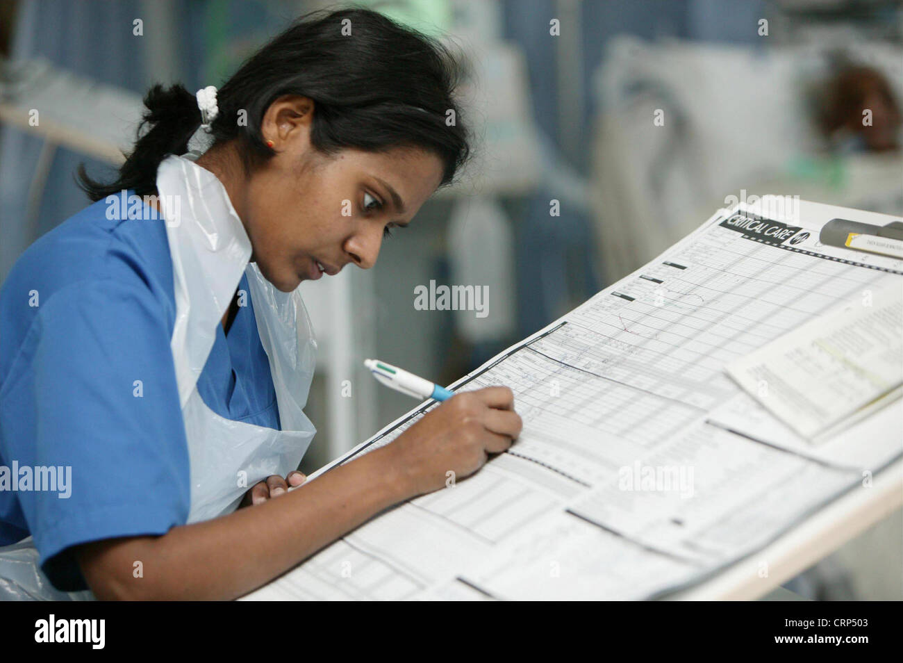 Una enfermera de redactar sus registros del paciente. Foto de stock
