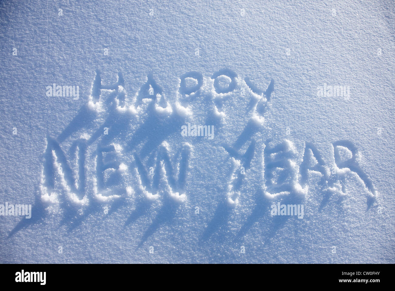Feliz año nuevo escrito en la nieve Foto de stock